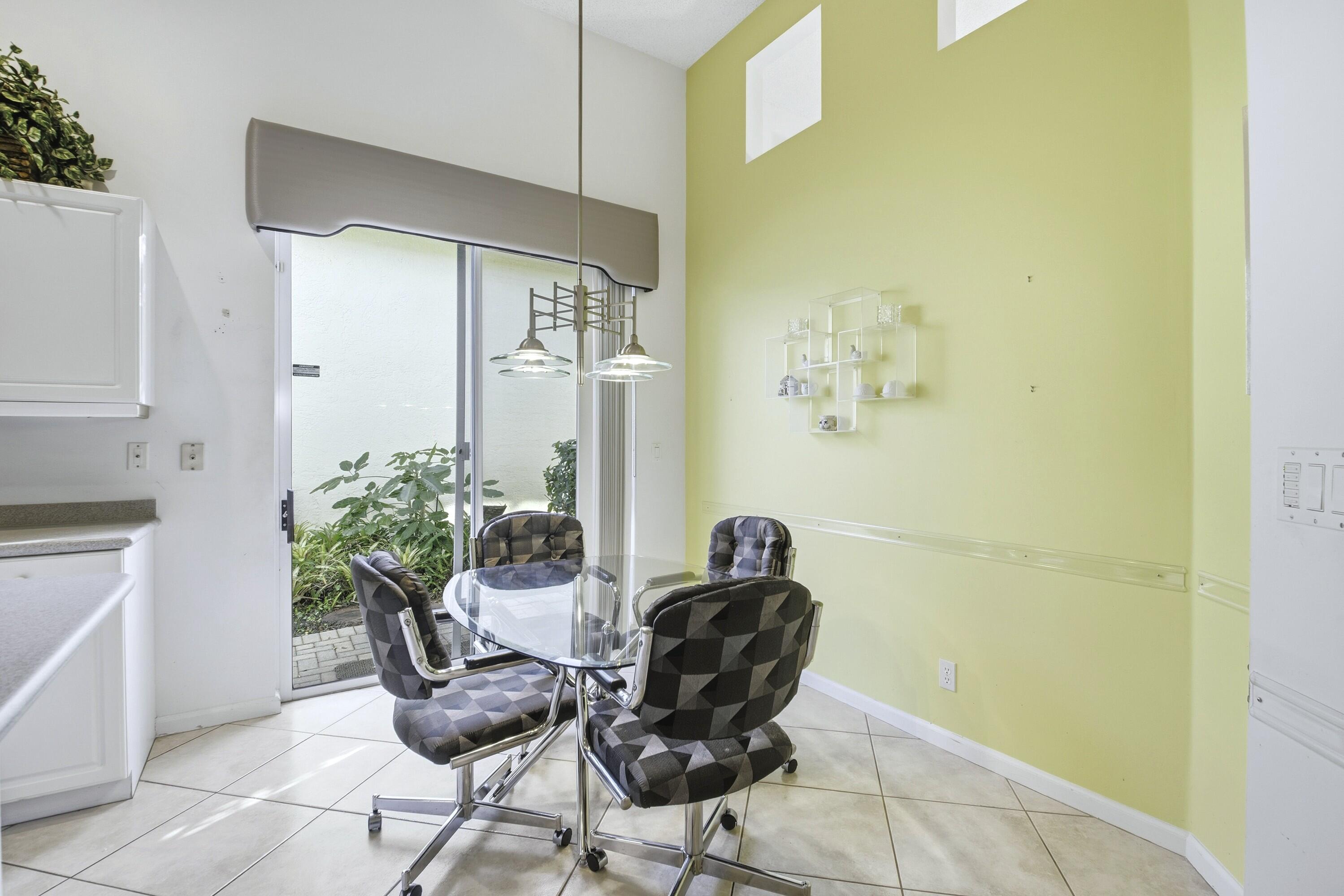 7737 Rockford Road Boynton Beach, FL 33472 - Photo 4 of 29 a living room with furniture and a potted plant