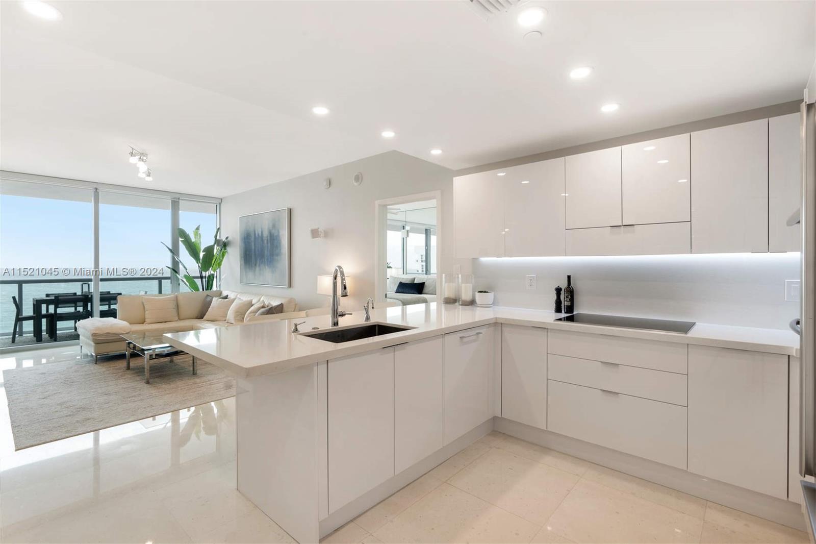 a kitchen with sink and white cabinets