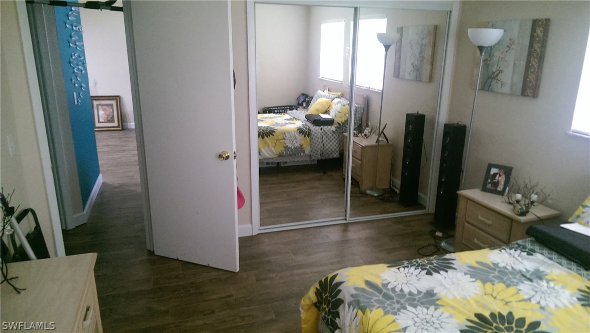 317 Maine Road Lehigh Acres, FL 33936 - Photo 2 of 5 a bedroom with a bed and a mirror