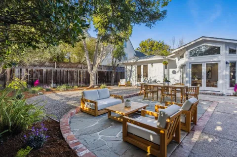 a view of backyard with seating and green space