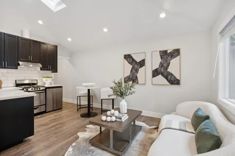 a kitchen with a sink cabinets and wooden floor