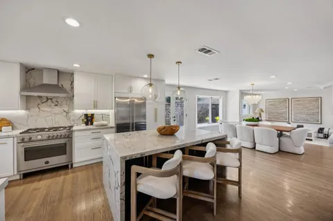 a large kitchen with a table and chairs