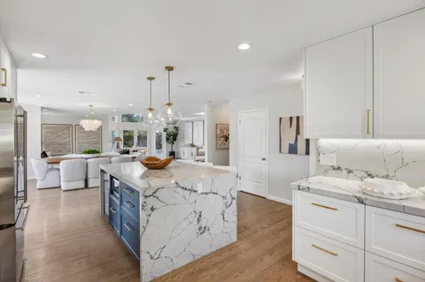 a view of a dining room with furniture wooden floor and chandelier
