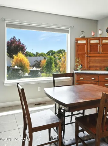 a view of a dining room with furniture window and outside view