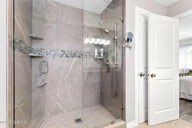 a bathroom with a glass shower door