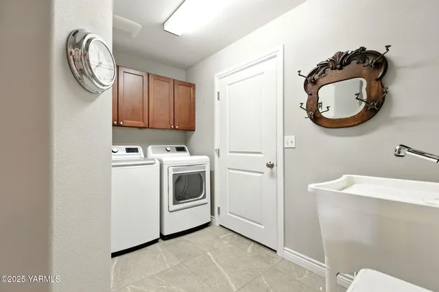 a view of a storage and utility room with a washer dryer