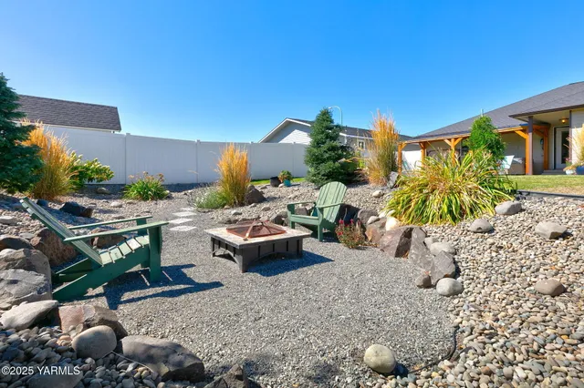 a view of a backyard with plants and patio