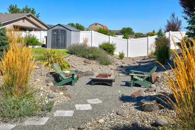 a view of a house with a yard and sitting area
