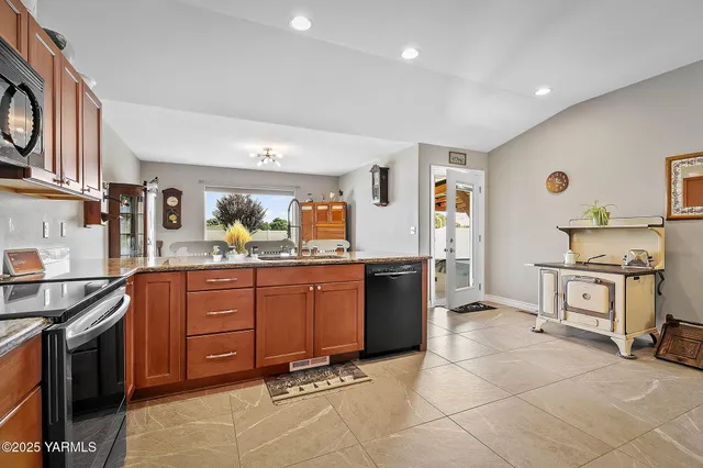 a kitchen with stainless steel appliances granite countertop a stove and a sink