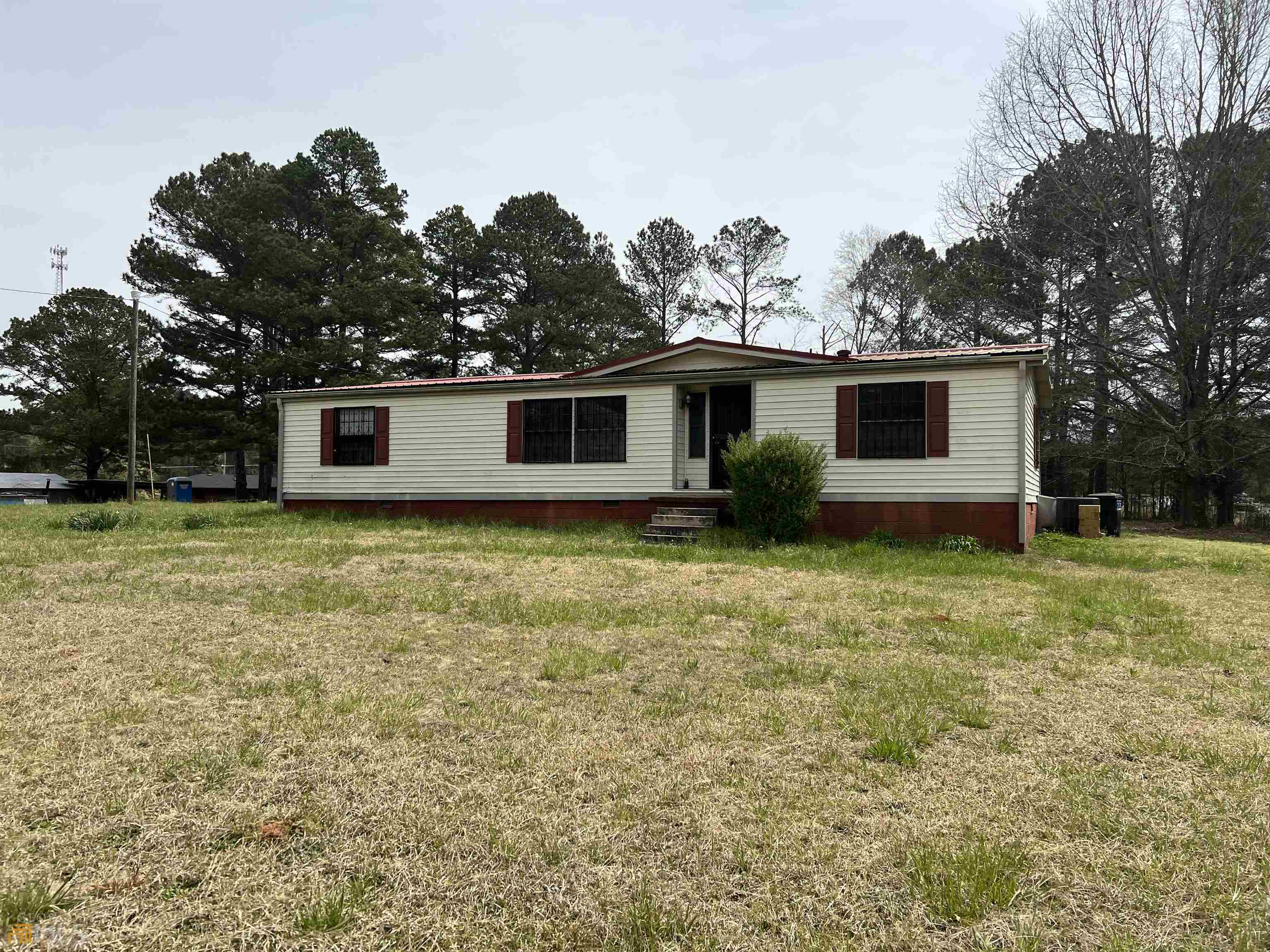 1075 Gratis Road Monroe, GA 30656 - Photo 1 of 1 a front view of house with yard and trees in the background