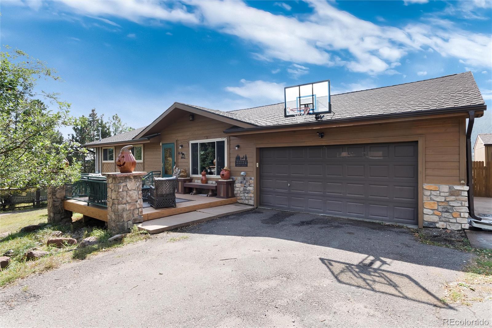 a front view of a house with yard and garage