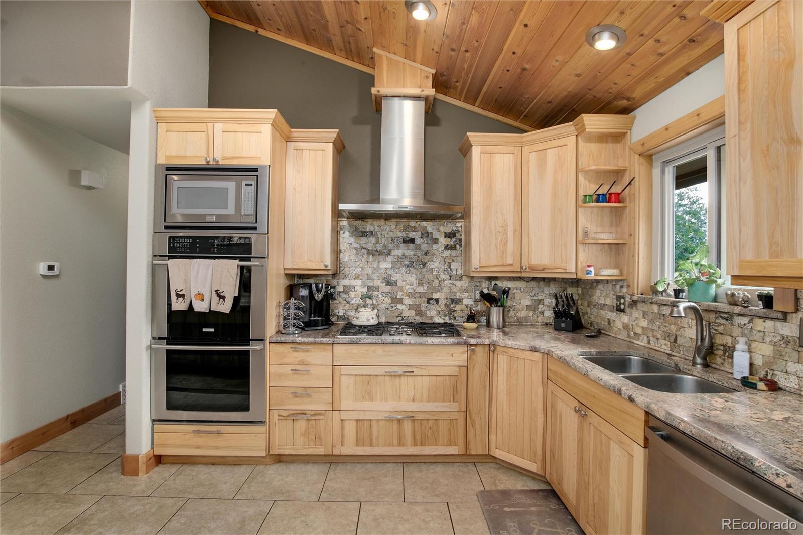 23724 Moqui Road Indian Hills, CO 80454 - Photo 14 of 39 a kitchen with stainless steel appliances granite countertop a sink and cabinets