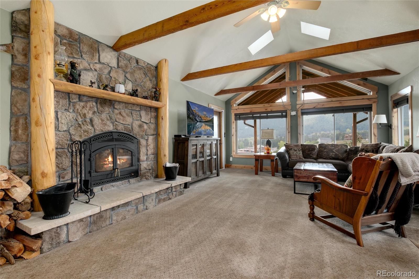 23724 Moqui Road Indian Hills, CO 80454 - Photo 17 of 39 a living room with furniture and a fireplace