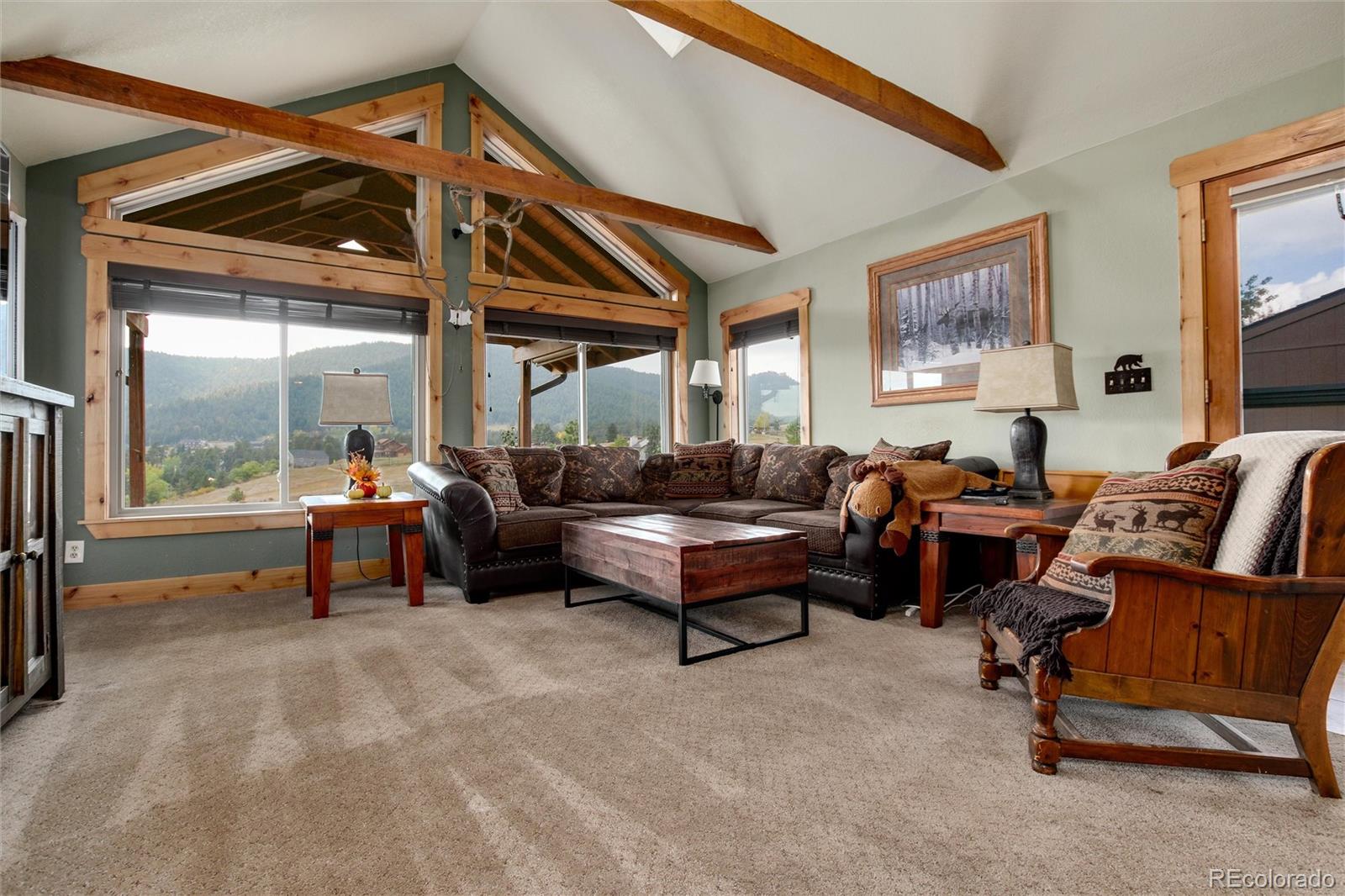 23724 Moqui Road Indian Hills, CO 80454 - Photo 18 of 39 a living room with furniture and a large window
