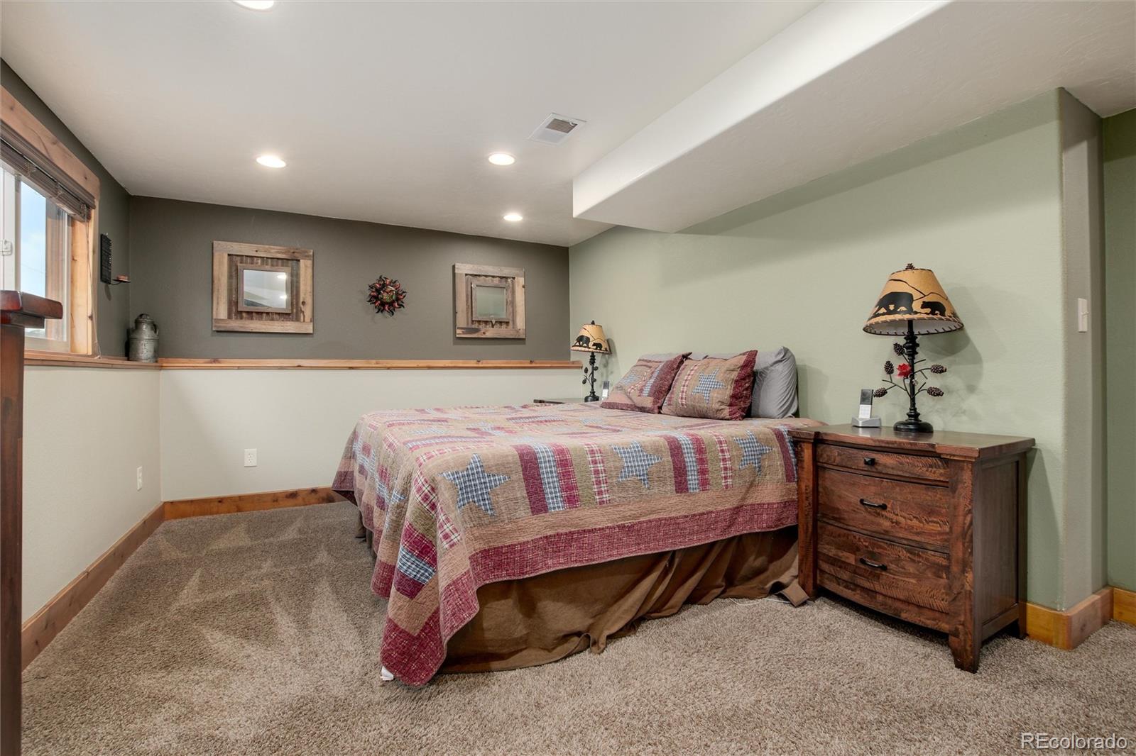 23724 Moqui Road Indian Hills, CO 80454 - Photo 19 of 39 a spacious bedroom with a bed and a cabinets