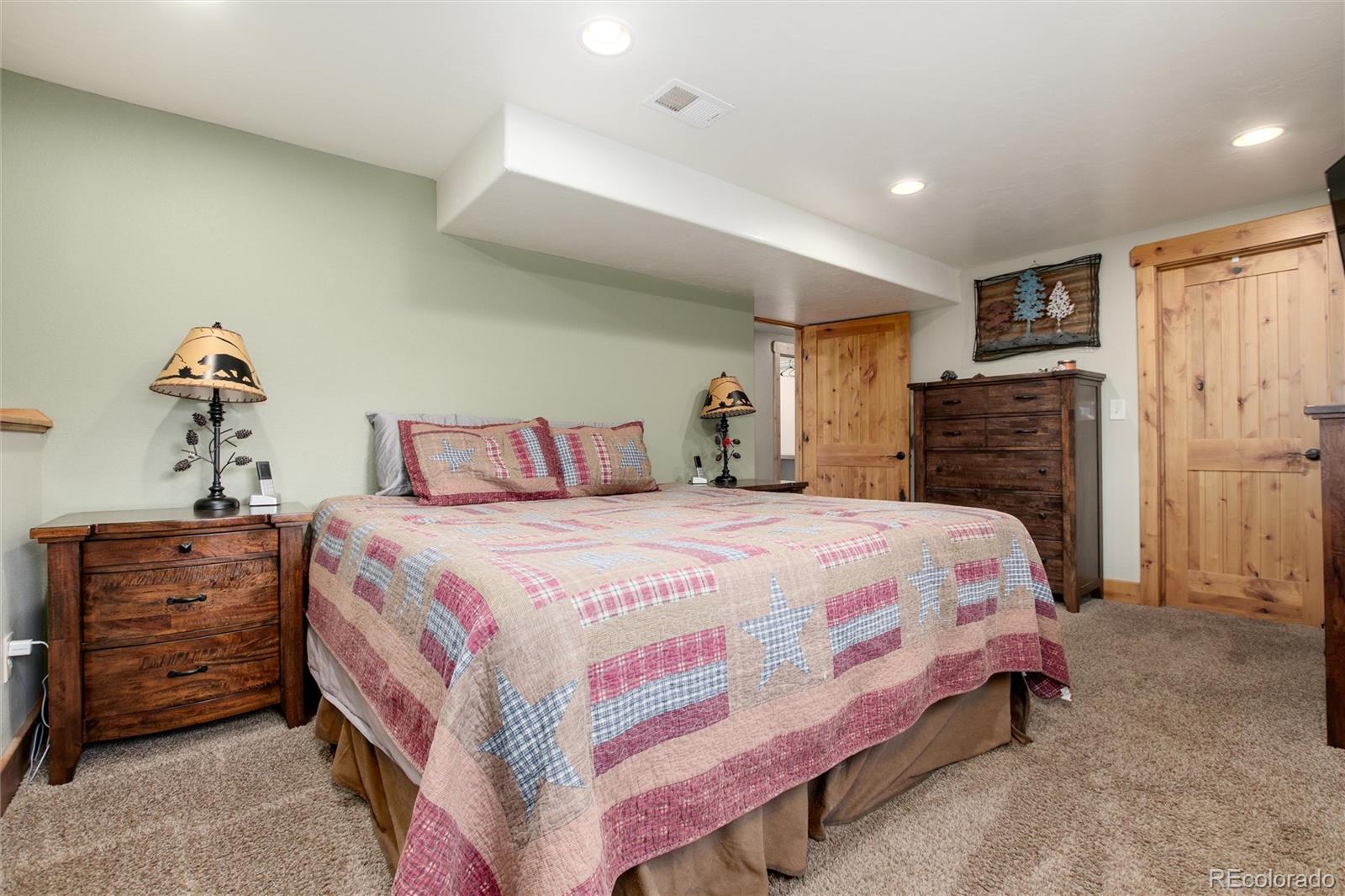 23724 Moqui Road Indian Hills, CO 80454 - Photo 20 of 39 a bedroom with a bed and furniture