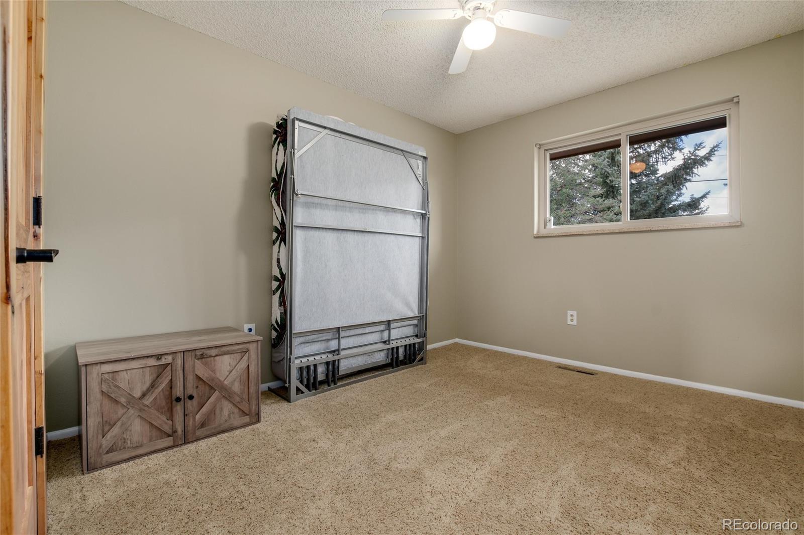 23724 Moqui Road Indian Hills, CO 80454 - Photo 23 of 39 an empty room with windows