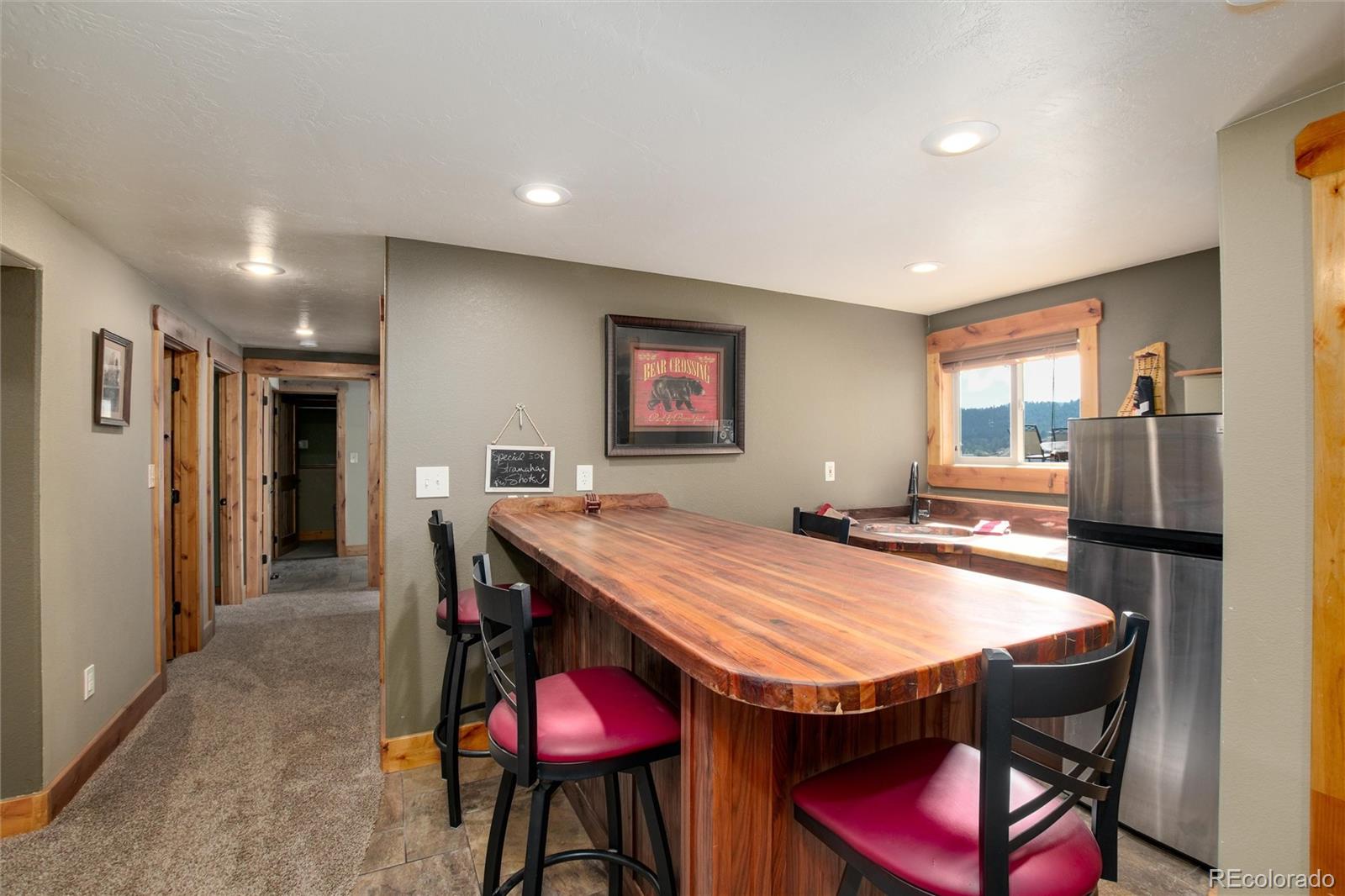 23724 Moqui Road Indian Hills, CO 80454 - Photo 29 of 39 a dining hall with stainless steel appliances kitchen island a table and chairs in it
