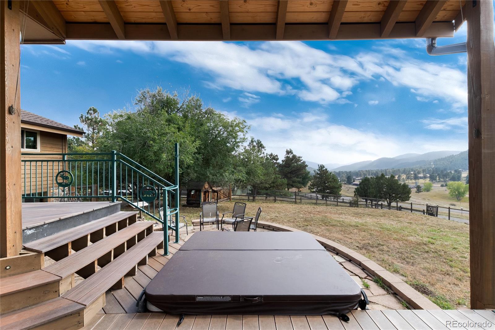 23724 Moqui Road Indian Hills, CO 80454 - Photo 34 of 39 a view of a swimming pool with a patio