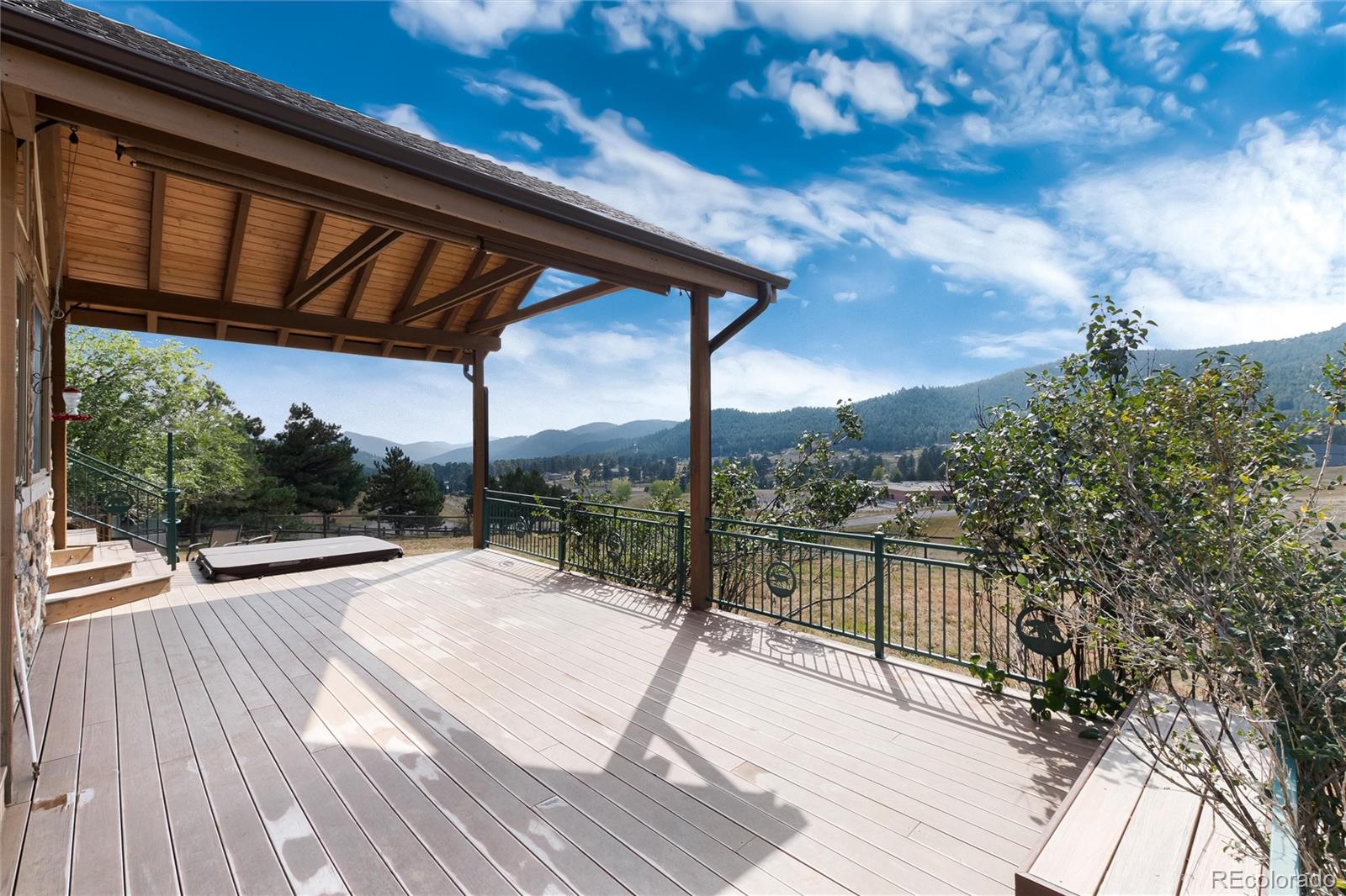 23724 Moqui Road Indian Hills, CO 80454 - Photo 35 of 39 a view of balcony with wooden floor and fence