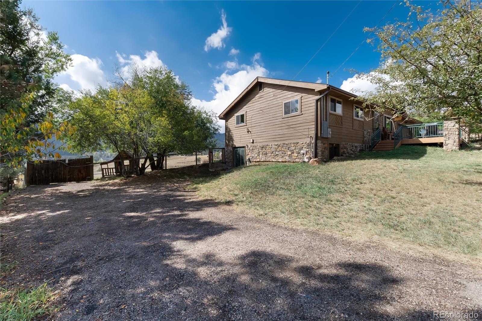 23724 Moqui Road Indian Hills, CO 80454 - Photo 38 of 39 a view of a house with a yard