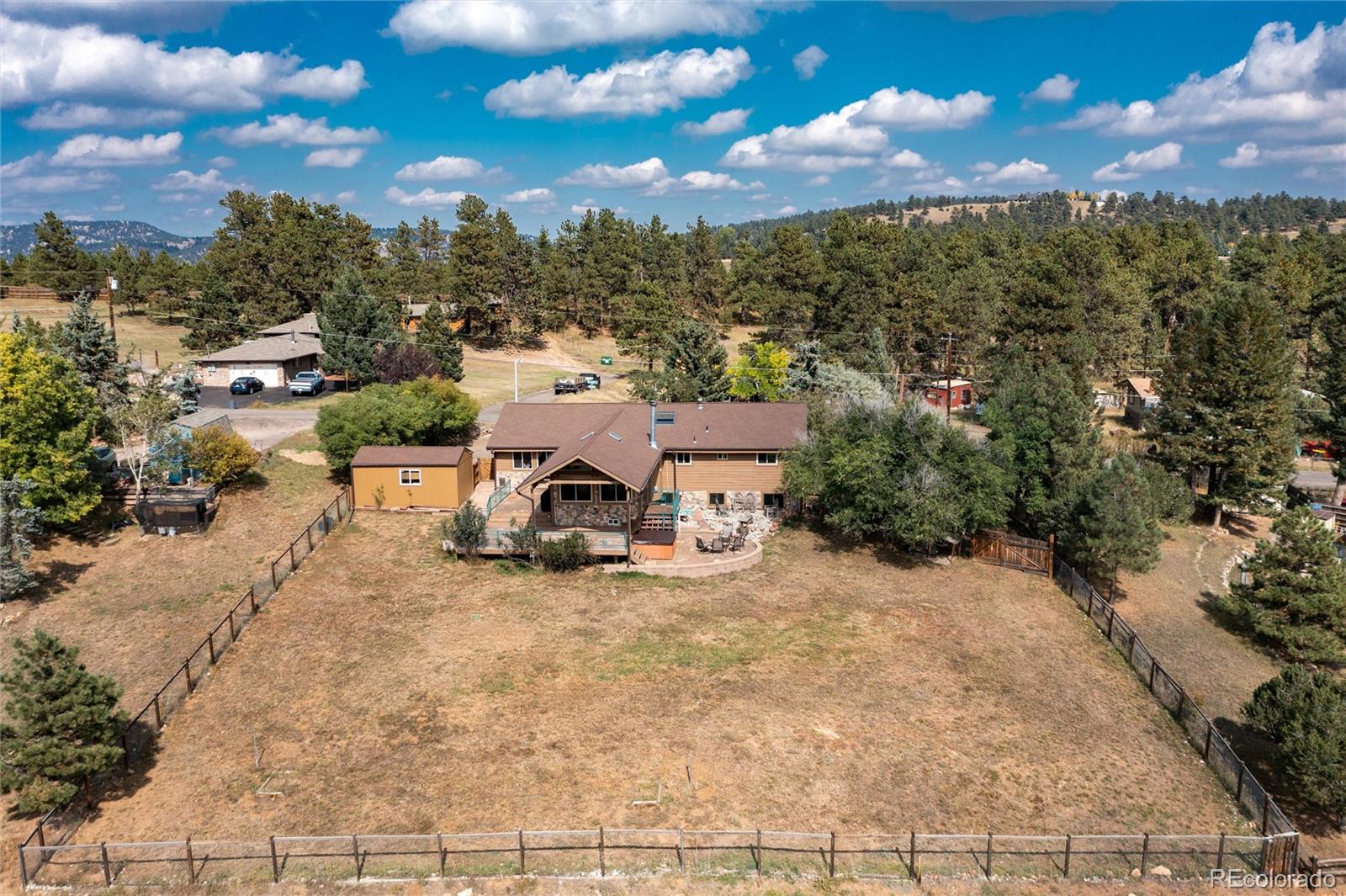 23724 Moqui Road Indian Hills, CO 80454 - Photo 4 of 39 a view of a patio with a table and chairs