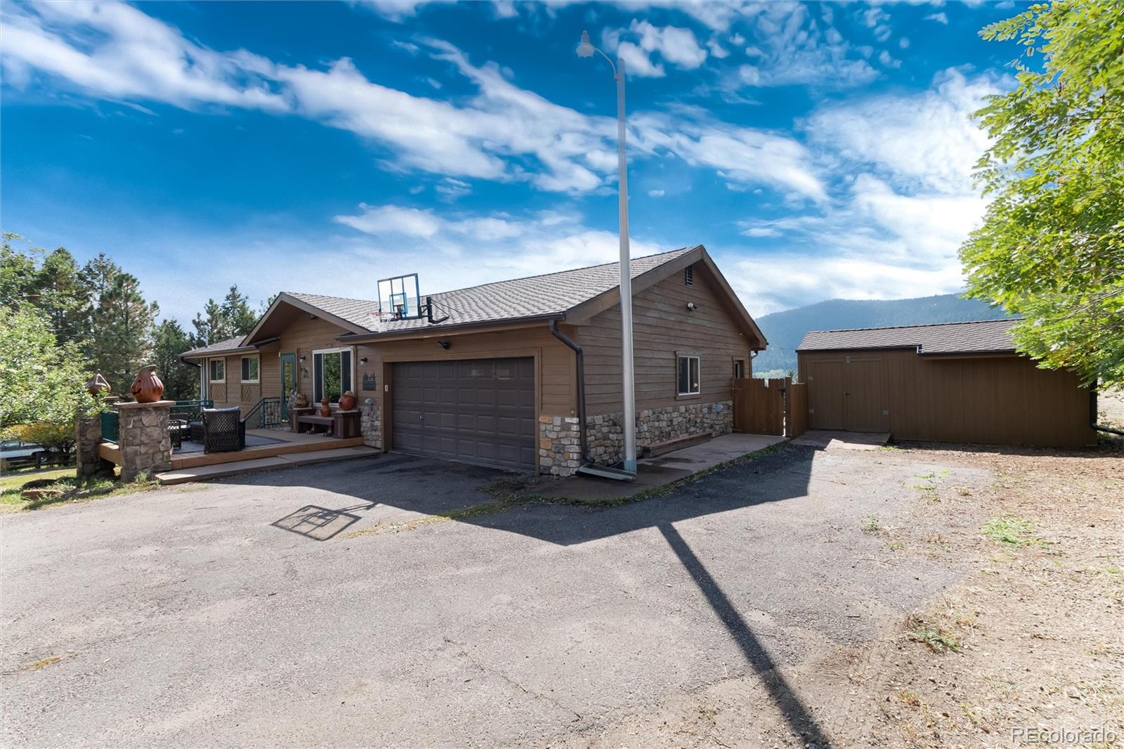 23724 Moqui Road Indian Hills, CO 80454 - Photo 6 of 39 a front view of a house with a yard