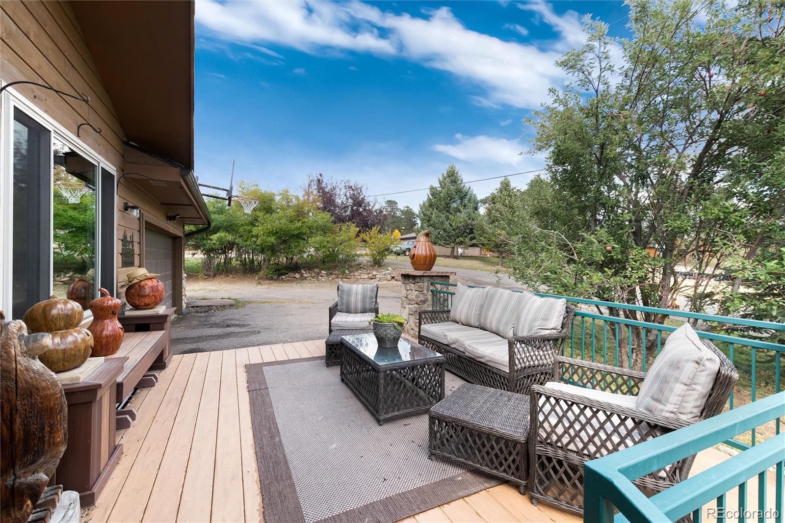 23724 Moqui Road Indian Hills, CO 80454 - Photo 7 of 39 a view of a patio with couches chairs and wooden floor