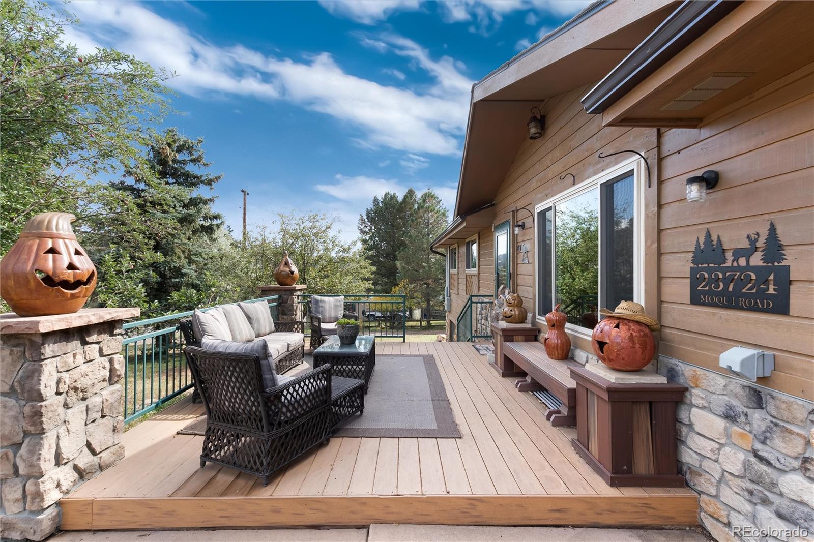 23724 Moqui Road Indian Hills, CO 80454 - Photo 9 of 39 a outdoor space with patio the couches and a potted plant