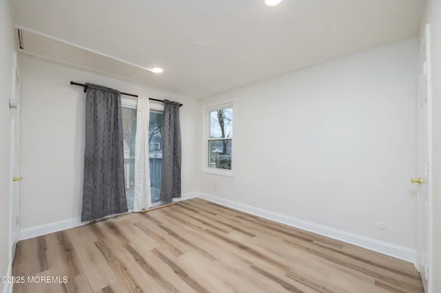 a view of a room with wooden floor and closet