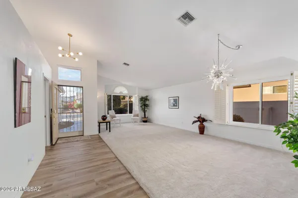a view of a livingroom with furniture window and a chandelier