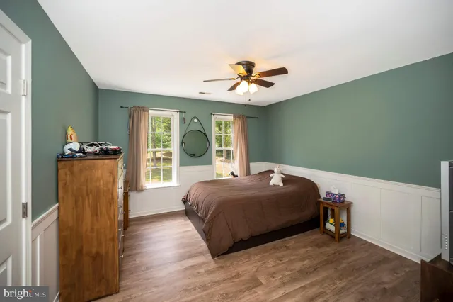 a bedroom with a bed and a mirror