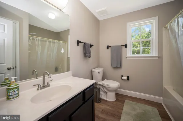 a bathroom with a sink toilet and a mirror