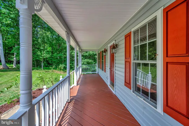 a view of balcony with floor to ceiling window wooden floor and fence