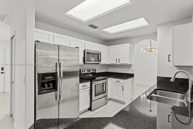 a kitchen with a sink stove and cabinets