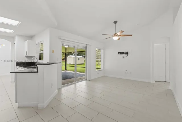 a view of a livingroom with a ceiling fan and window