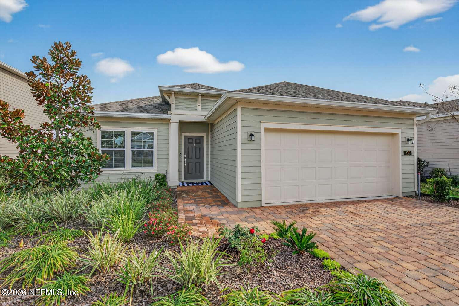 a front view of house with yard and trees around