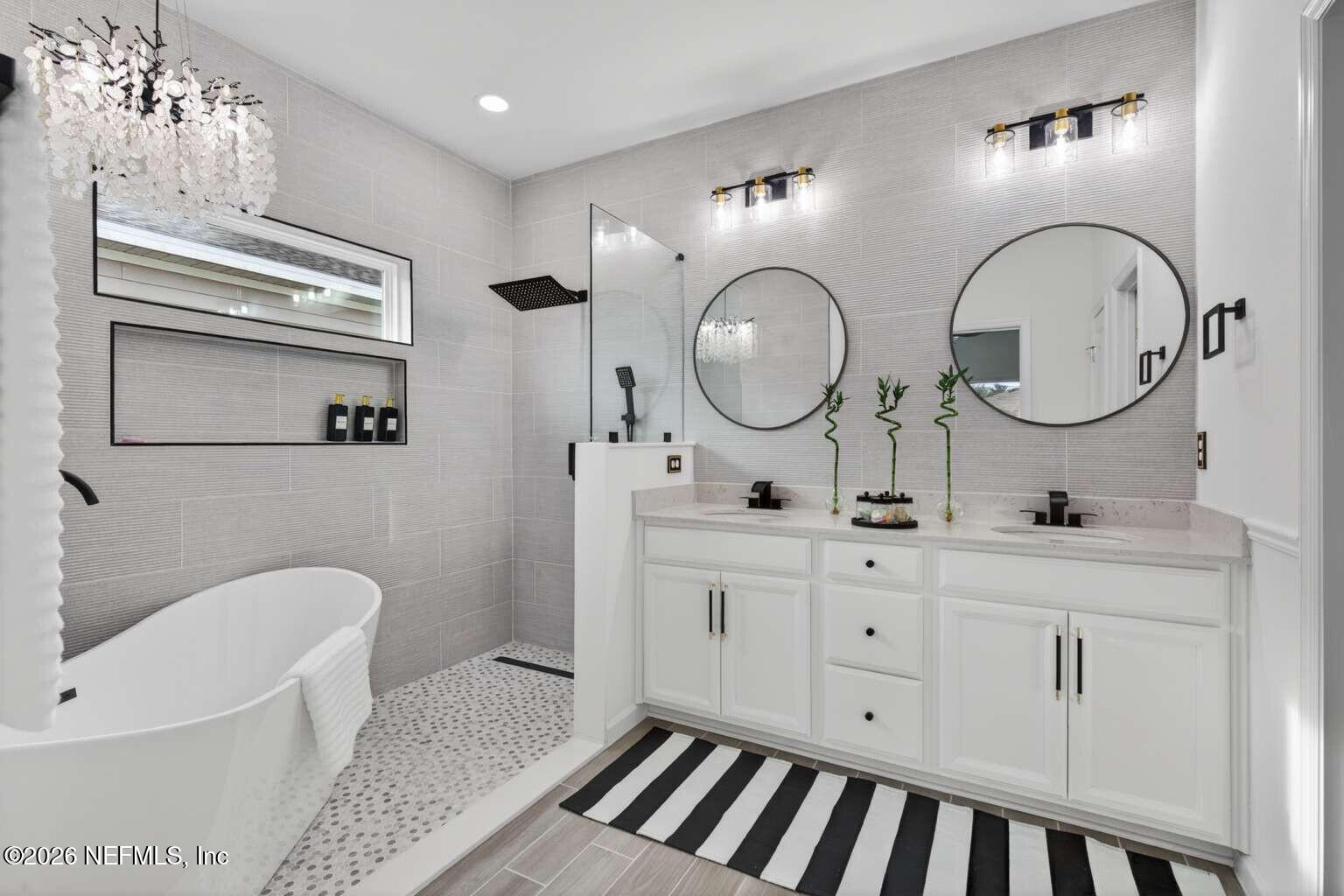 339 Gan Way St. Johns, FL 32259 - Photo 11 of 20 a spacious bathroom with a double vanity sink and a mirror