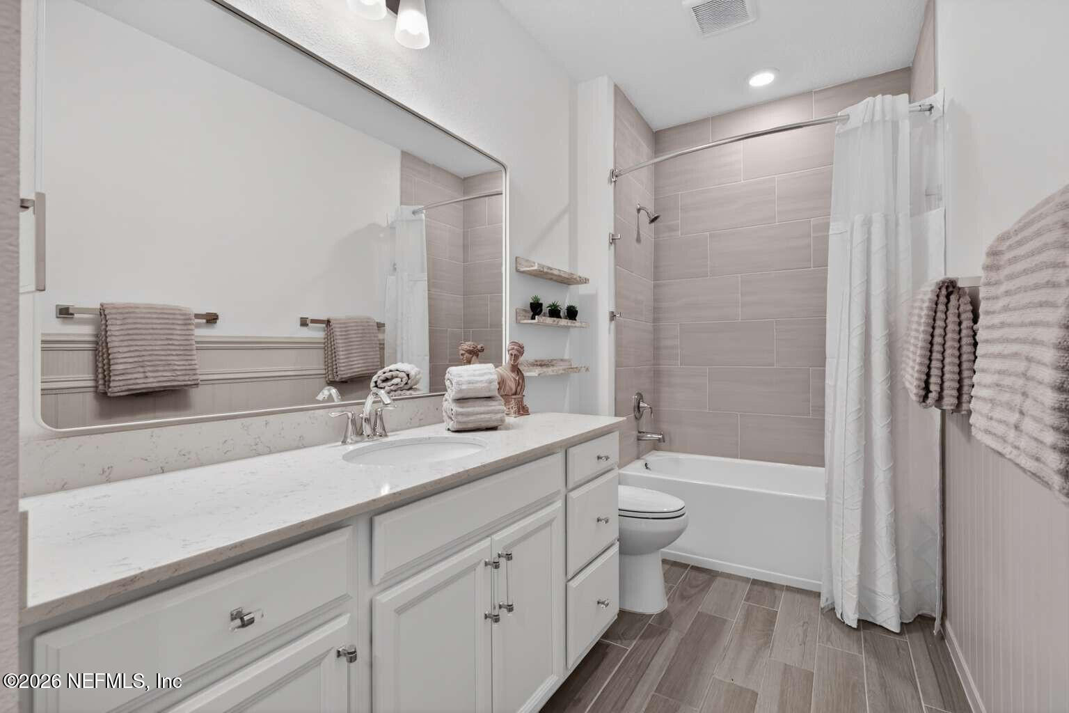 339 Gan Way St. Johns, FL 32259 - Photo 15 of 20 a bathroom with a double vanity sink toilet and shower