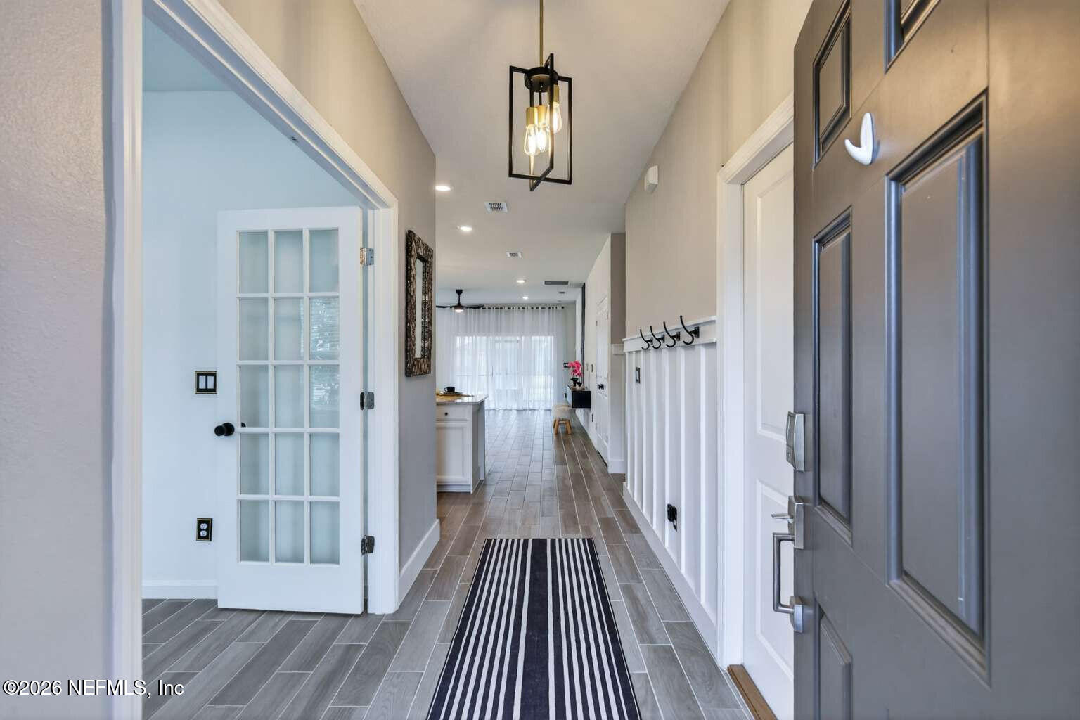 339 Gan Way St. Johns, FL 32259 - Photo 2 of 20 a view of a hallway with wooden floor and staircase