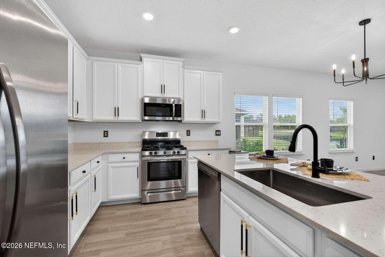 339 Gan Way St. Johns, FL 32259 - Photo 3 of 20 a kitchen with stainless steel appliances granite countertop a sink a stove and a refrigerator