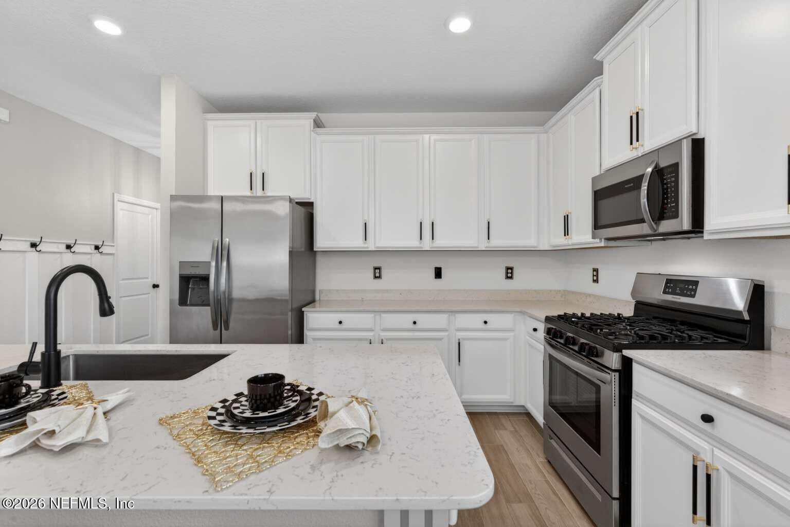 339 Gan Way St. Johns, FL 32259 - Photo 4 of 20 a kitchen with stainless steel appliances a stove a sink a refrigerator and cabinets
