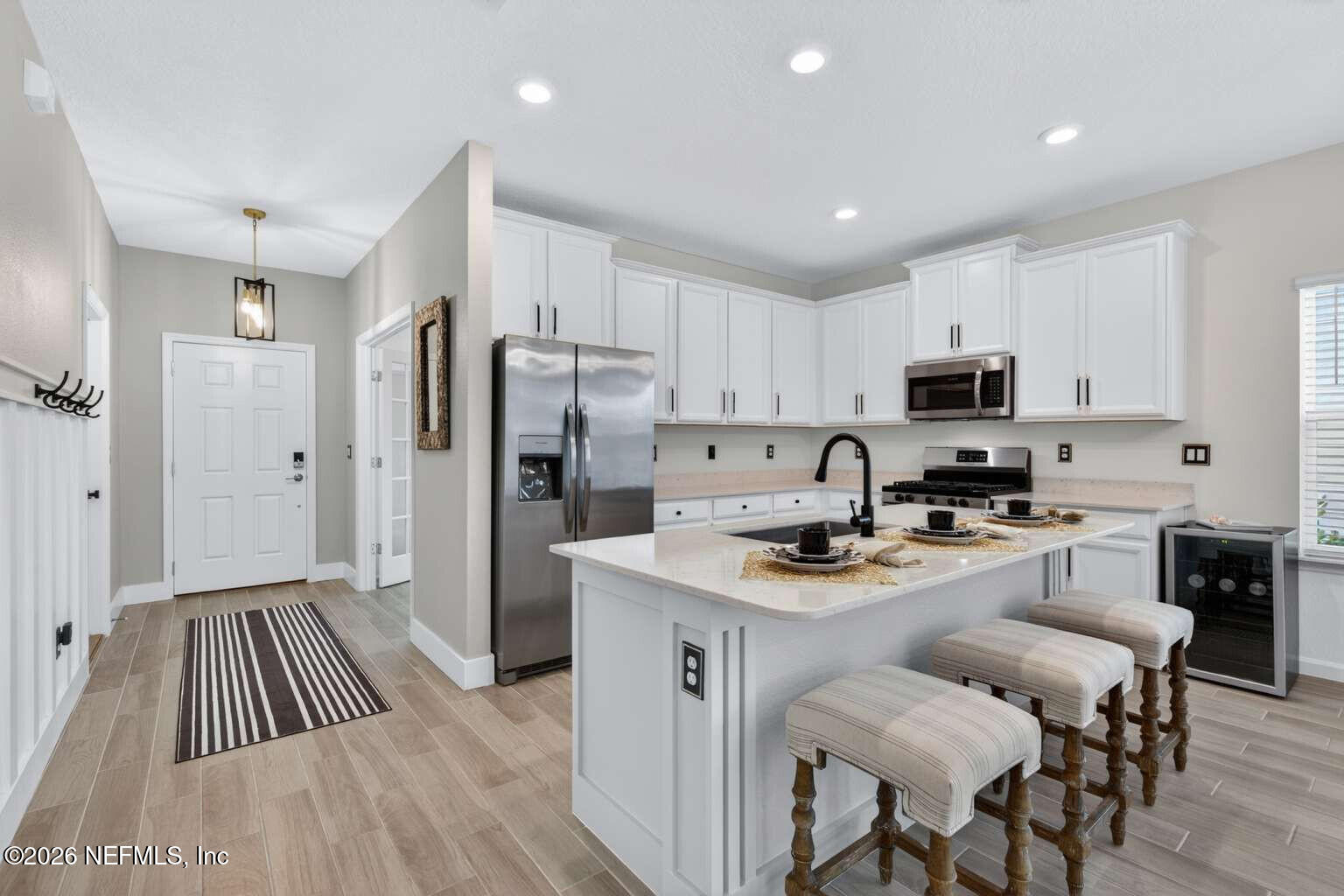 339 Gan Way St. Johns, FL 32259 - Photo 5 of 20 a kitchen with white cabinets and stainless steel appliances