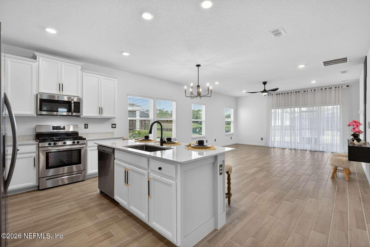 339 Gan Way St. Johns, FL 32259 - Photo 6 of 20 a kitchen with granite countertop a sink cabinets and stainless steel appliances