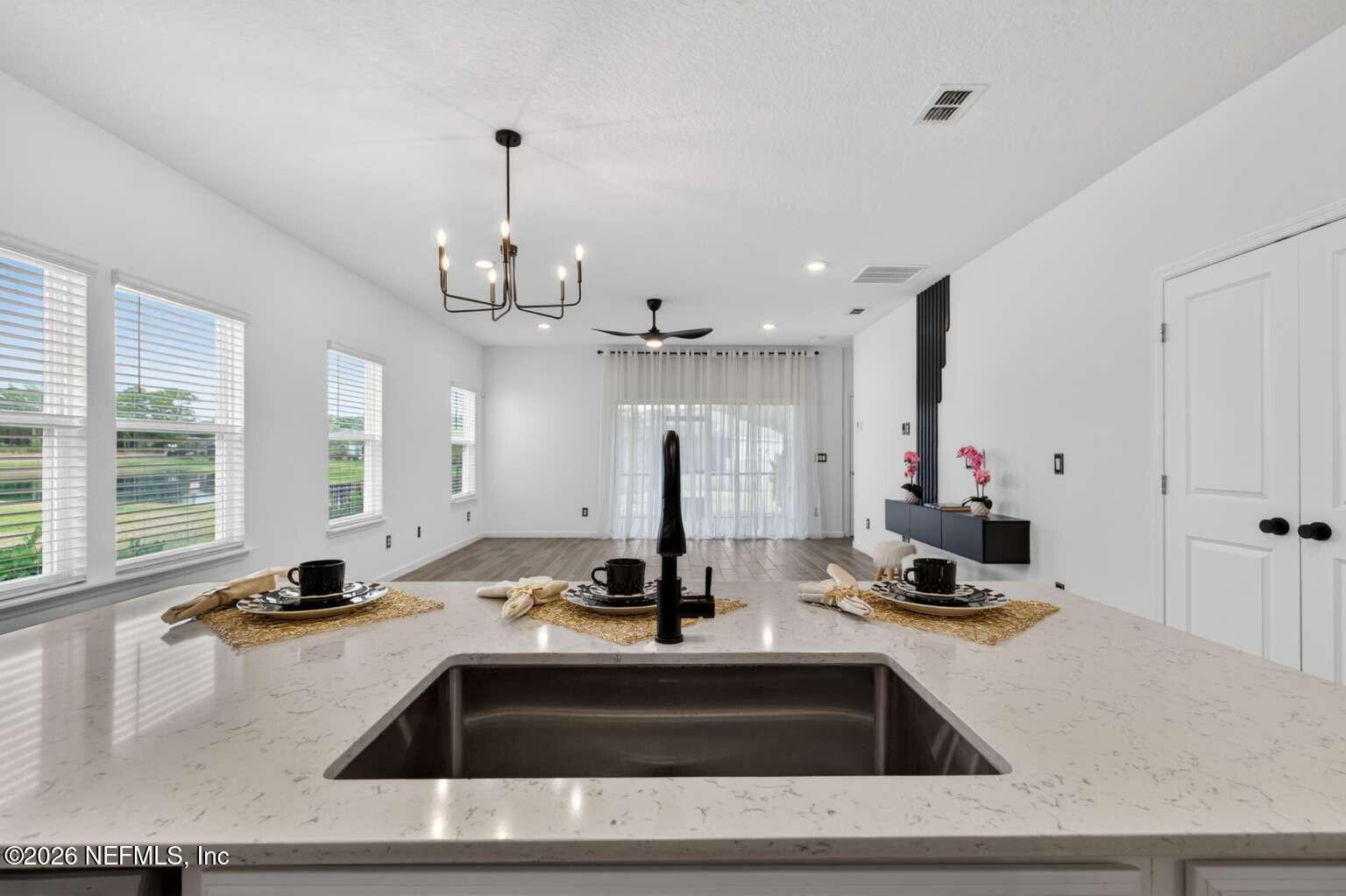 339 Gan Way St. Johns, FL 32259 - Photo 8 of 20 a view of a kitchen with kitchen island a sink stainless steel appliances and a window