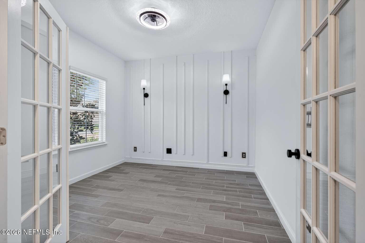 339 Gan Way St. Johns, FL 32259 - Photo 9 of 20 a view of an empty room with wooden floor and a window