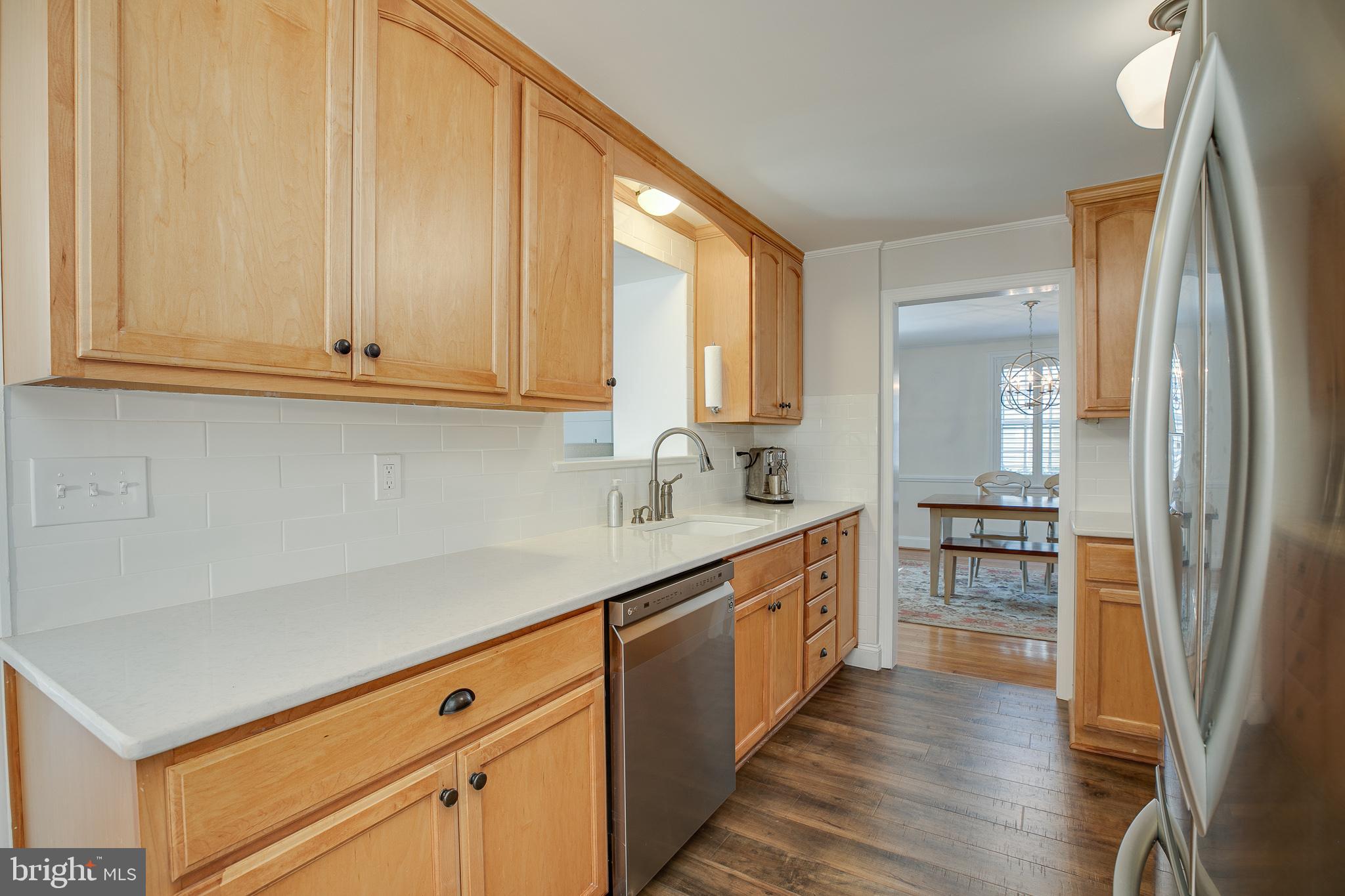 330 Old Lancaster Road Devon, PA 19333 - Photo 8 of 31 a kitchen with stainless steel appliances granite countertop a refrigerator a sink dishwasher a stove and white countertops with wooden floor