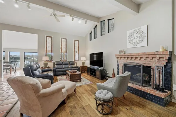 a living room with furniture a fireplace and a flat screen tv