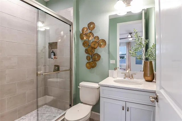 a bedroom with a bed desk and chair