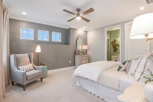 a bedroom with a bed and a lamp